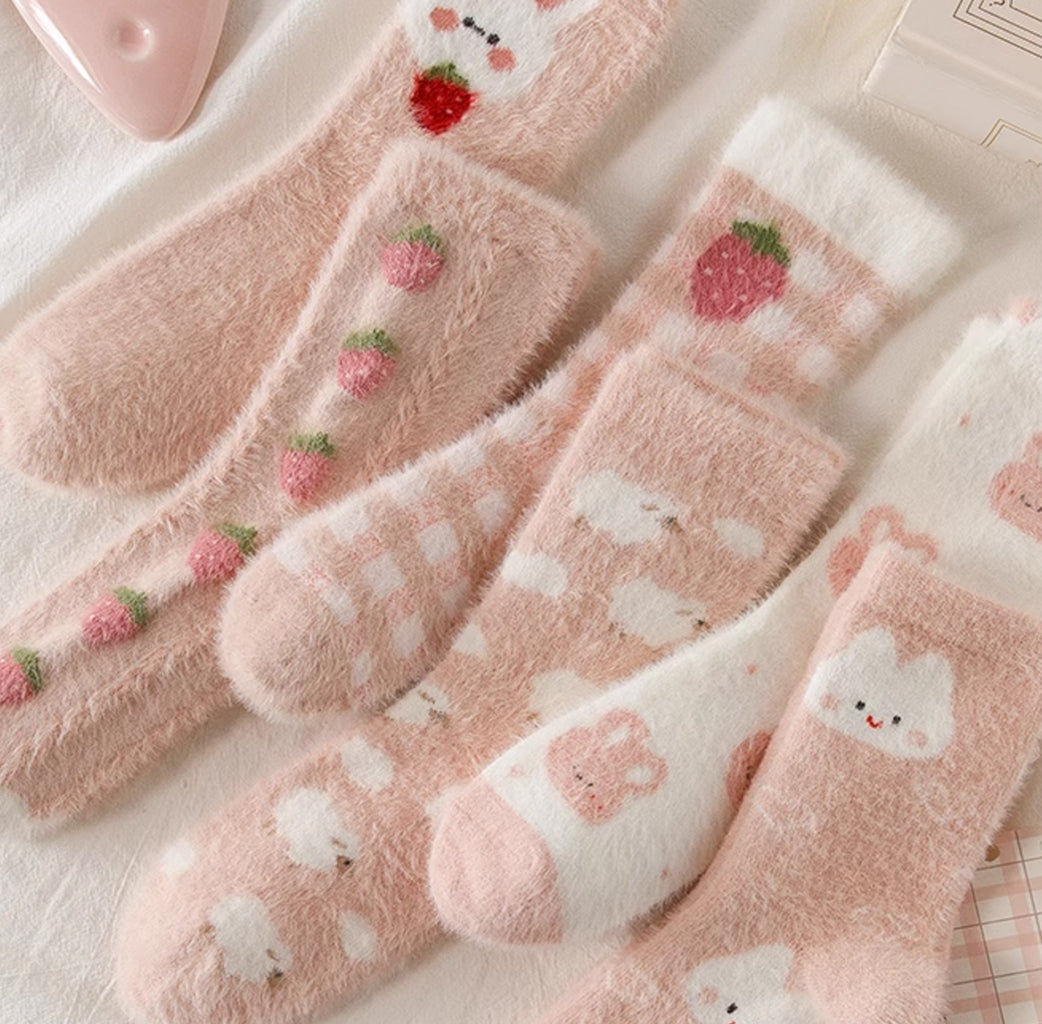 Stay cozy and warm during chilly winter days with Caramella's thickened coral fleece mid-calf socks
